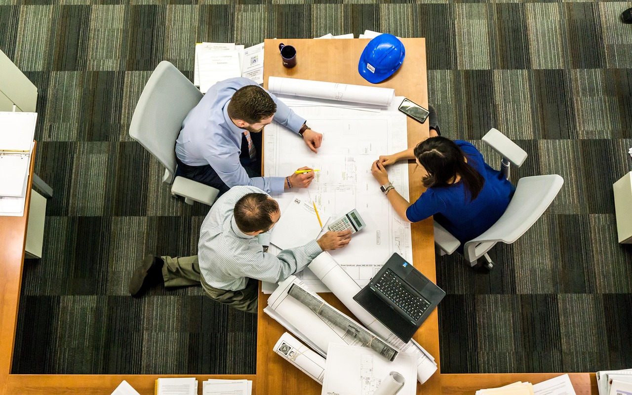 Business team reviewing project plans around a table